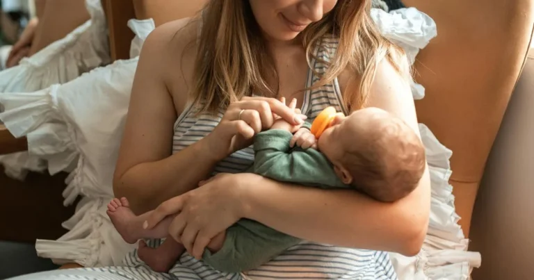 Mother feeding baby with pacifier in arms – names with tu