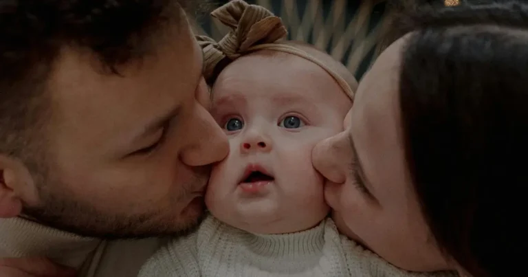Loving parents kiss baby girl with bow headband, showcasing family warmth and ja girl namee inspiration