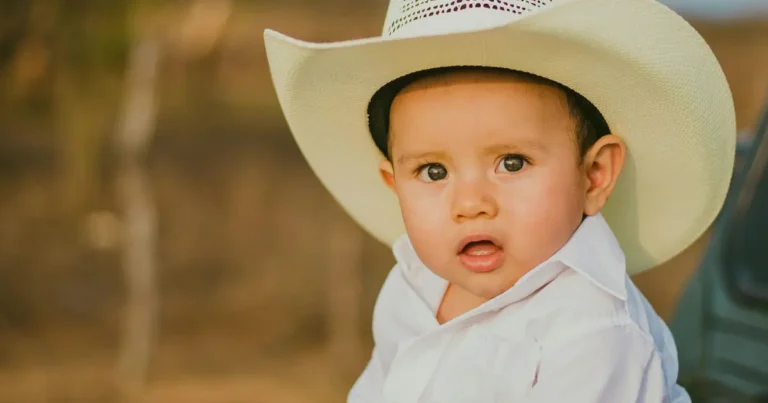 A western child wearing a cowboy hat and a white shirt indicates that the child is of western descent.
