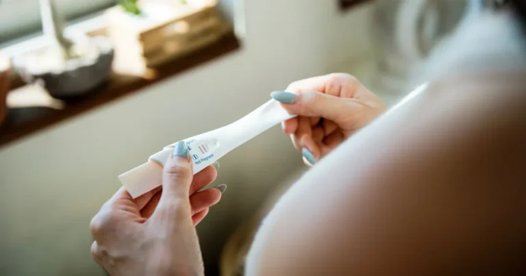 Woman checking an easy home pregnancy test with a positive result