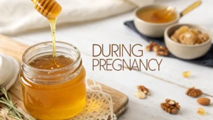Honey in a glass jar with a honey dipper, illustrating the use of honey during pregnancy.
