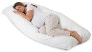 Pregnant woman sleeping comfortably on a white pregnancy body pillow case providing full body support.
